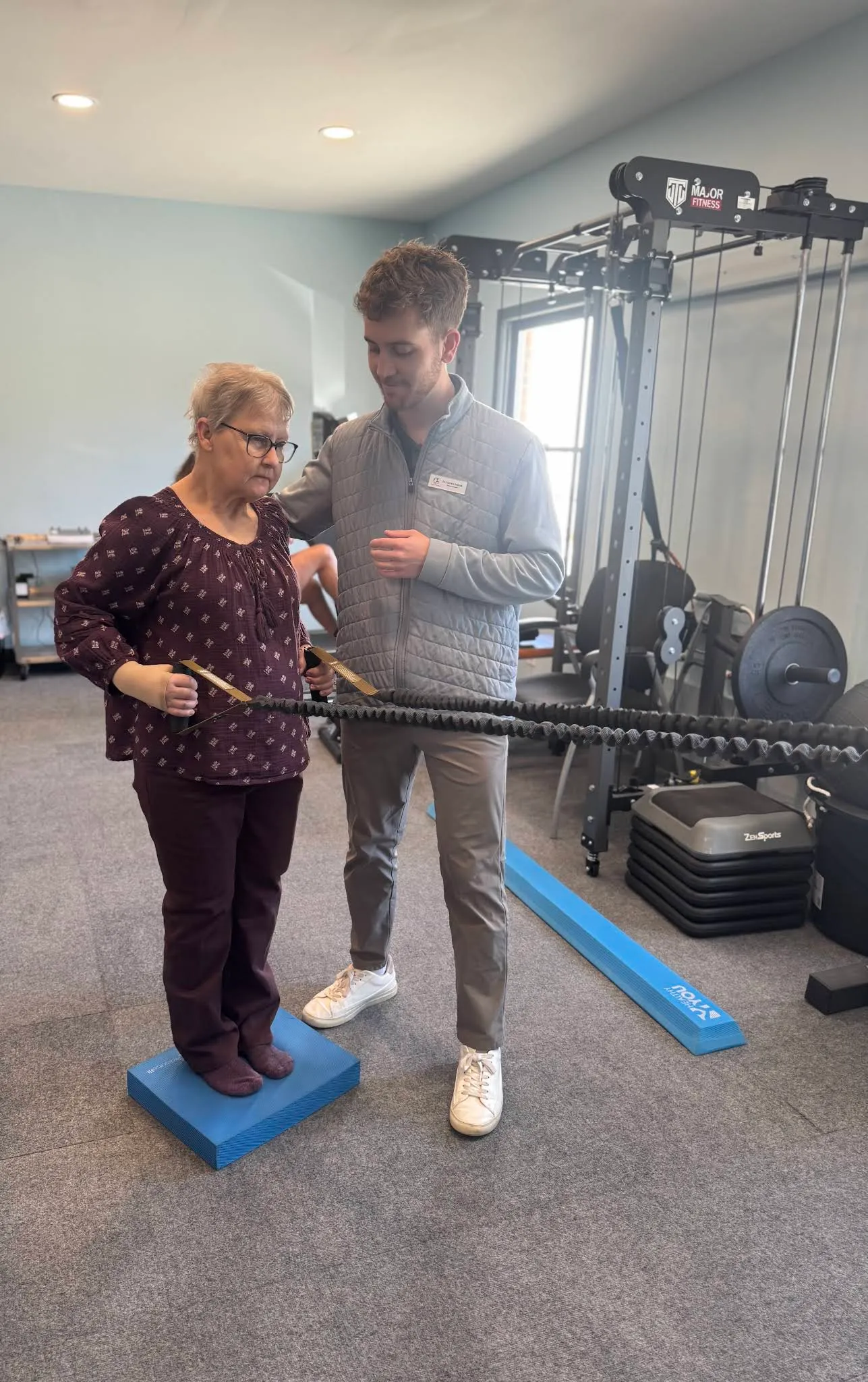A Beyond Physical Therapy clinician helping a patient with balance training in the Spring Hill clinic.
