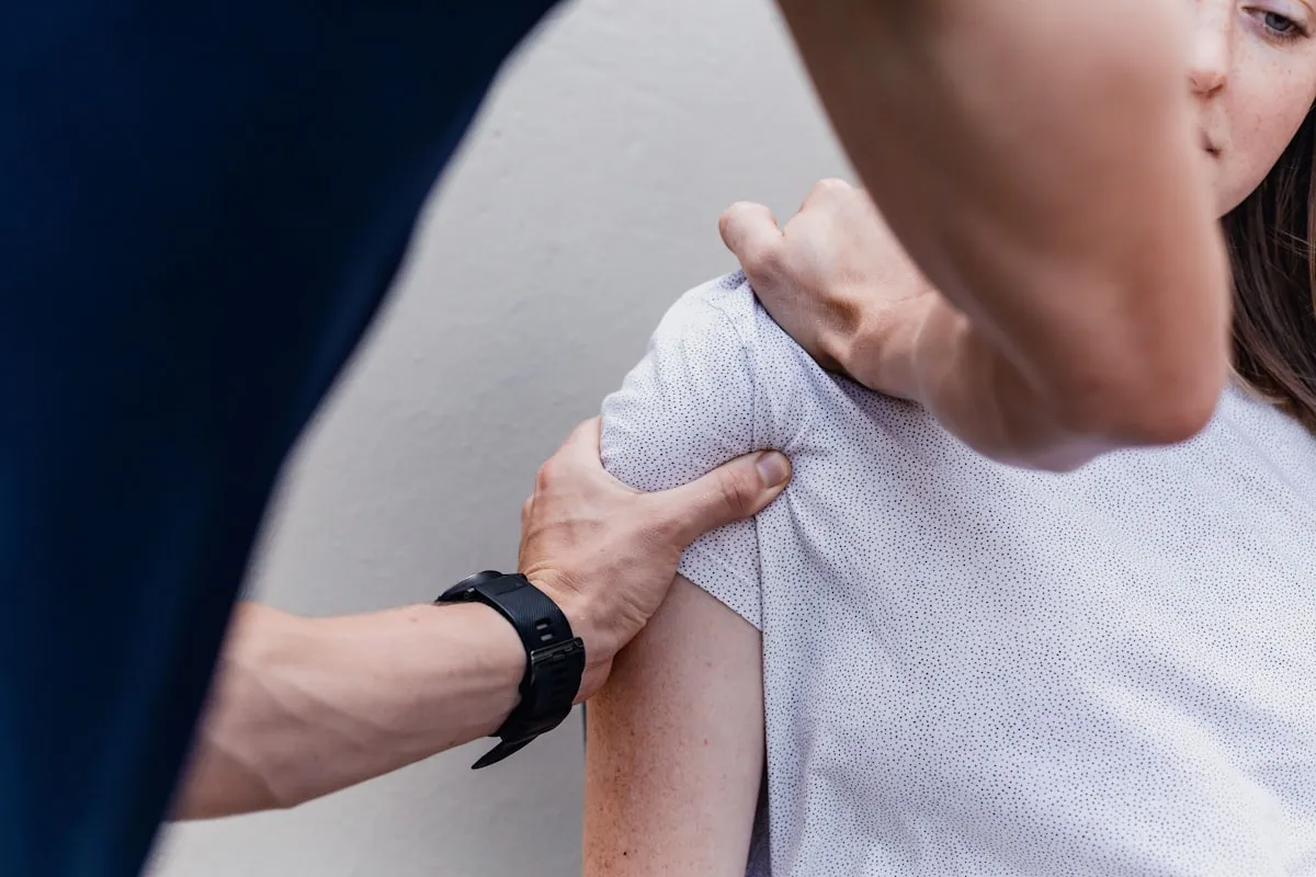 A therapist working with a patient on hand and shoulder mobility.